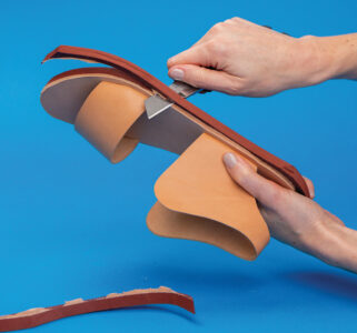 trimming rubber outer sole with sharp knife